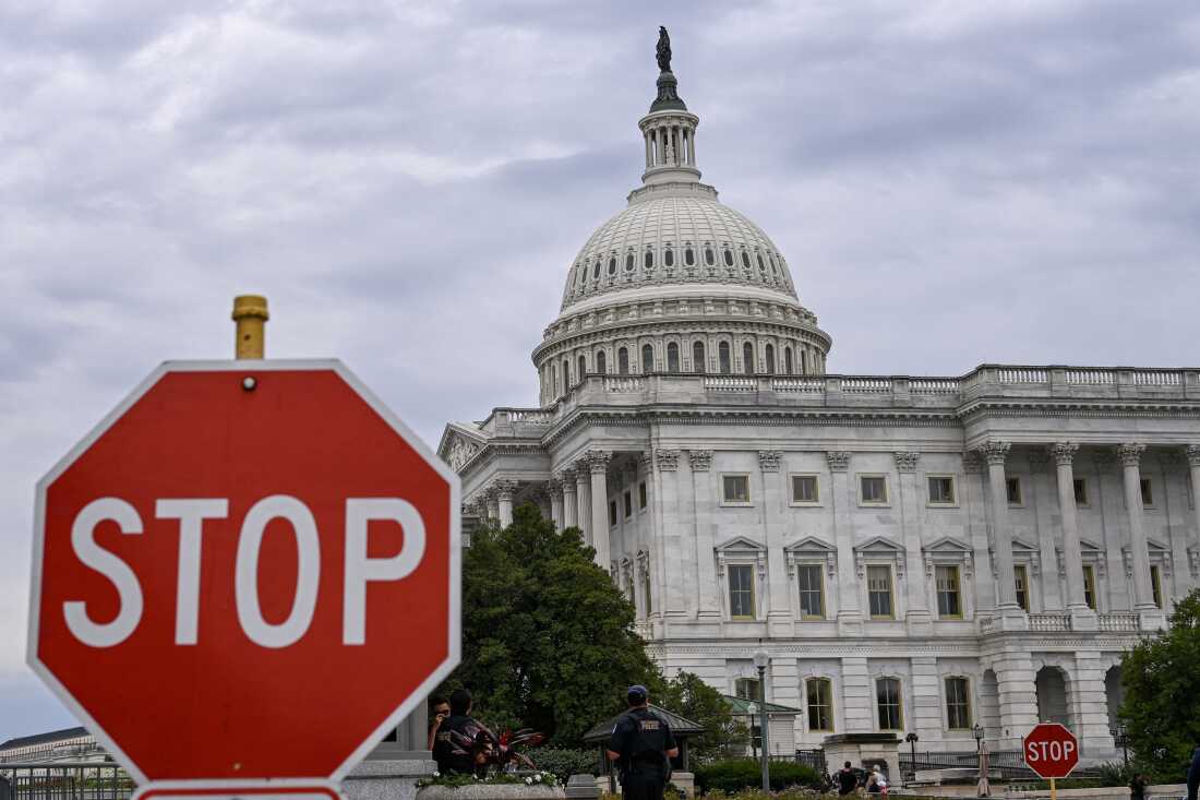 A stop sign is seen in front of the US Capitol dome in Washington, DC, on September 30, 2025. The United States government was barreling towards its first shutdown in six years Tuesday, with funding expiring at midnight barring a breakthrough on deadlocked negotiations between Democrats and Republicans. (Photo by Alex WROBLEWSKI / AFP) (Photo by ALEX WROBLEWSKI/AFP via Getty Images)